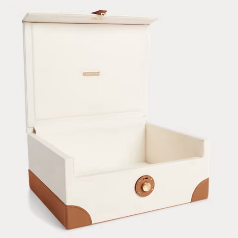 Crafted of supple leather and finished with brass hardware, this storage box.